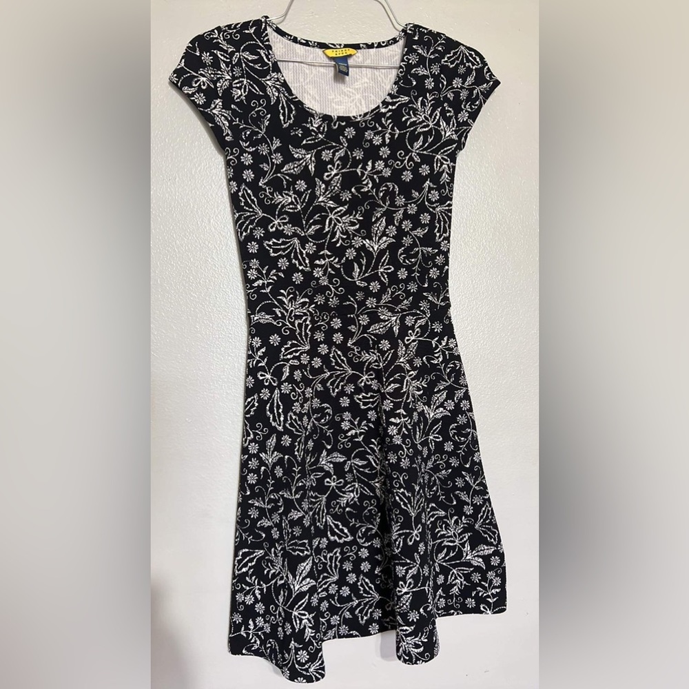 Cute woman black short dress with white floral